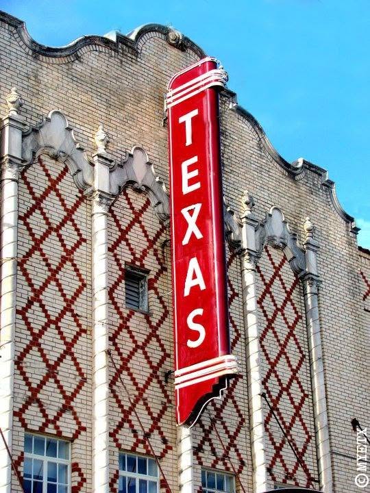 The red TEXAS blade sign on the theater's Spanish Colonial facade